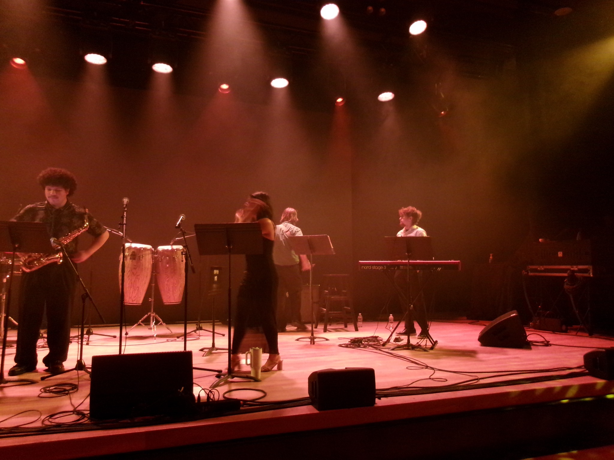 Orquesta Afinke performing beneath warm stage lights